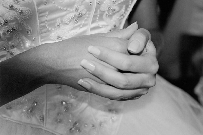 A black and white photo of a bride's hands.