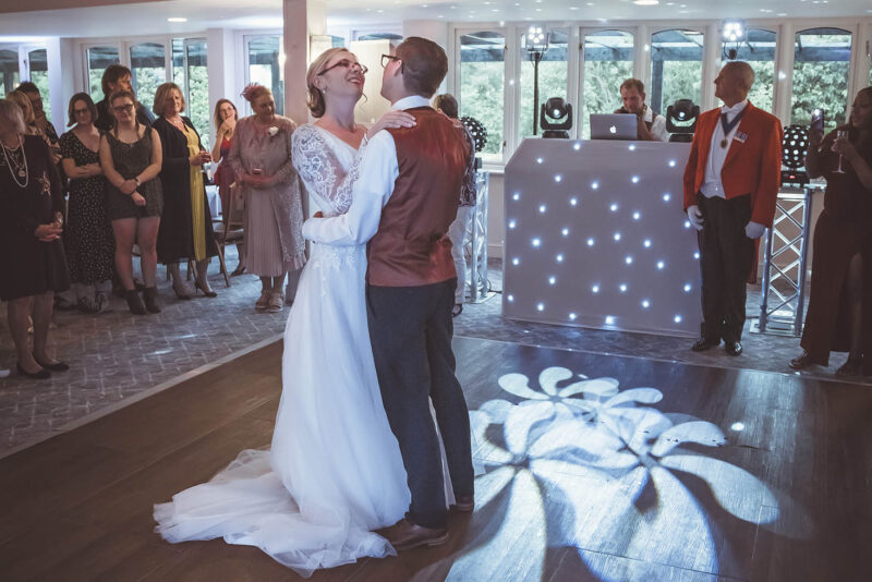 A bride and groom sharing their first dance at their wedding reception.