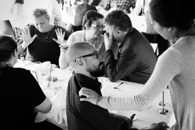 A black and white photo of a group of people at a table.